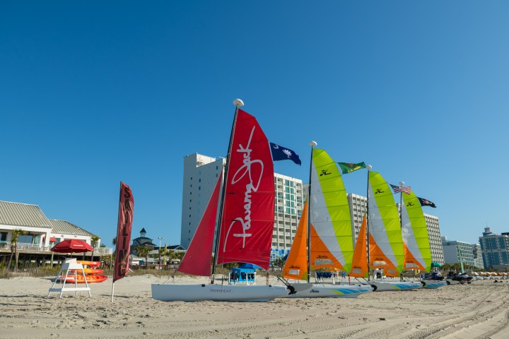 a boat sitting on top of a sandy beach