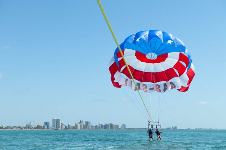 a parachute is sitting next to a body of water