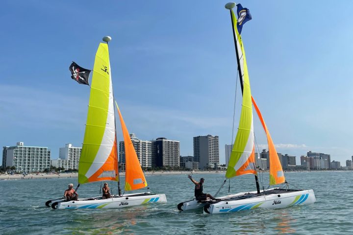 a group of people on a sailboat ride in myrtle beach